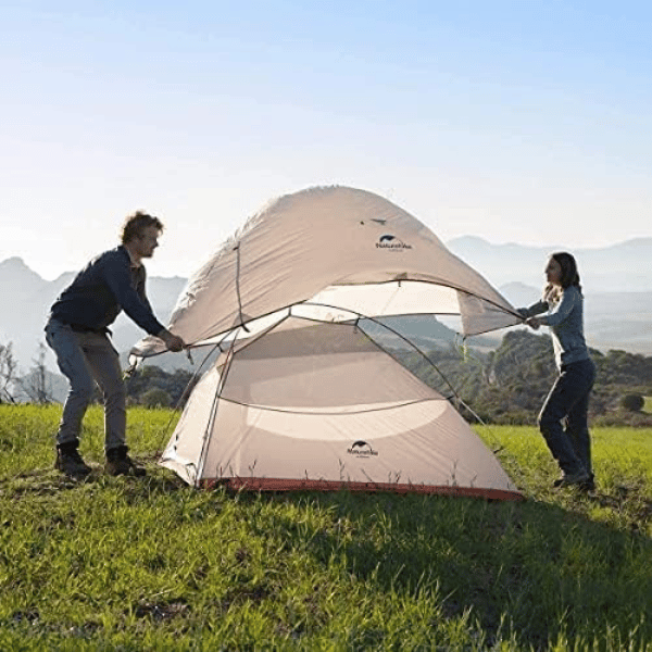 White Tent in on grass in Mountains - best-backpacking-tents-under-200-dollars