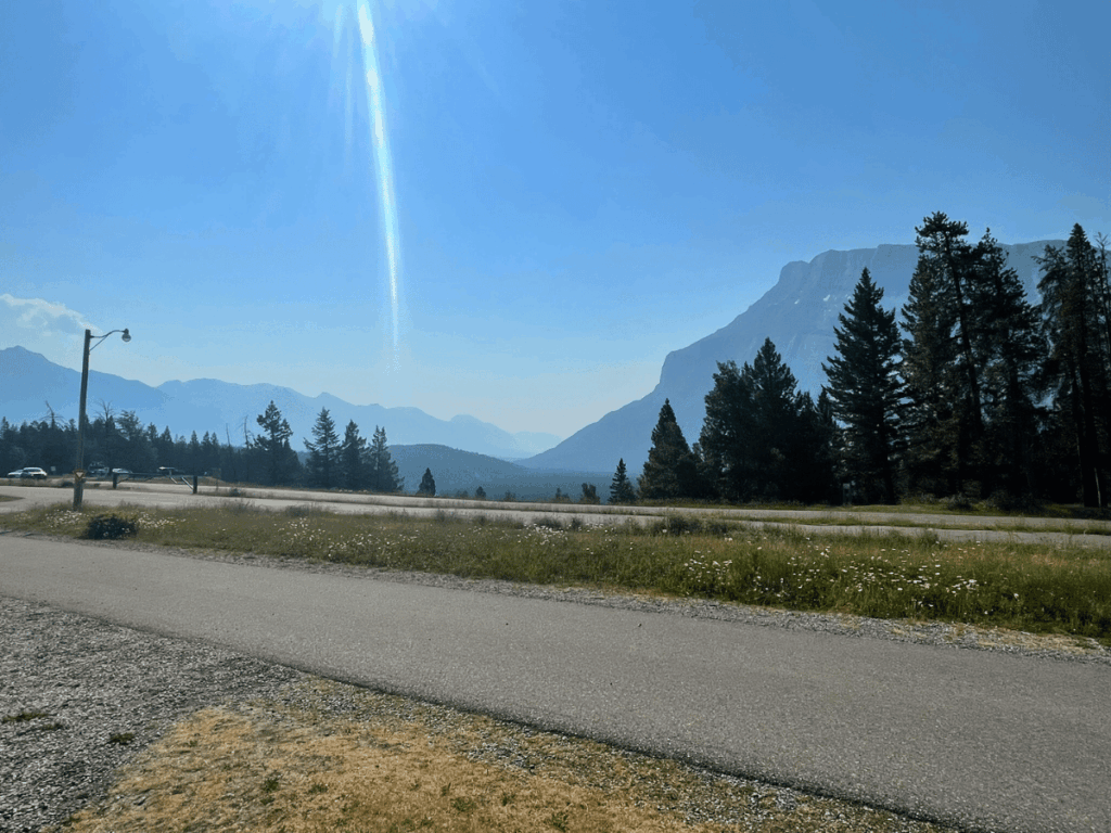 mountains in the distance with a road way - tunnel mountain