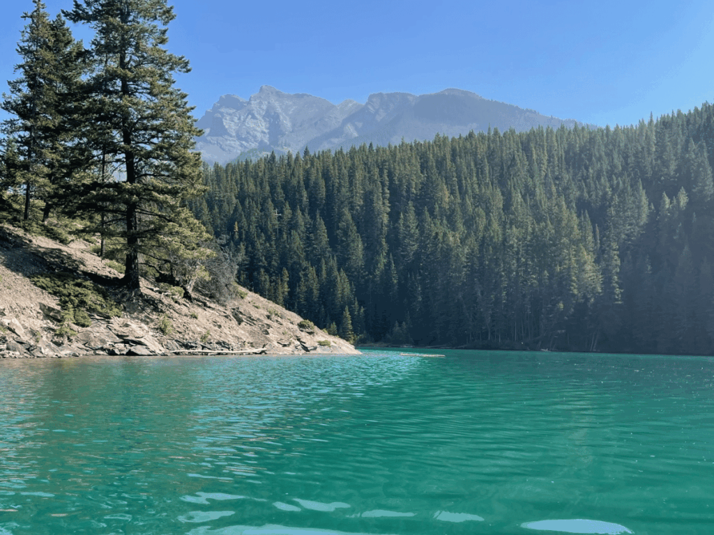 Tourqiuse water with mountains and forest - two jack lake