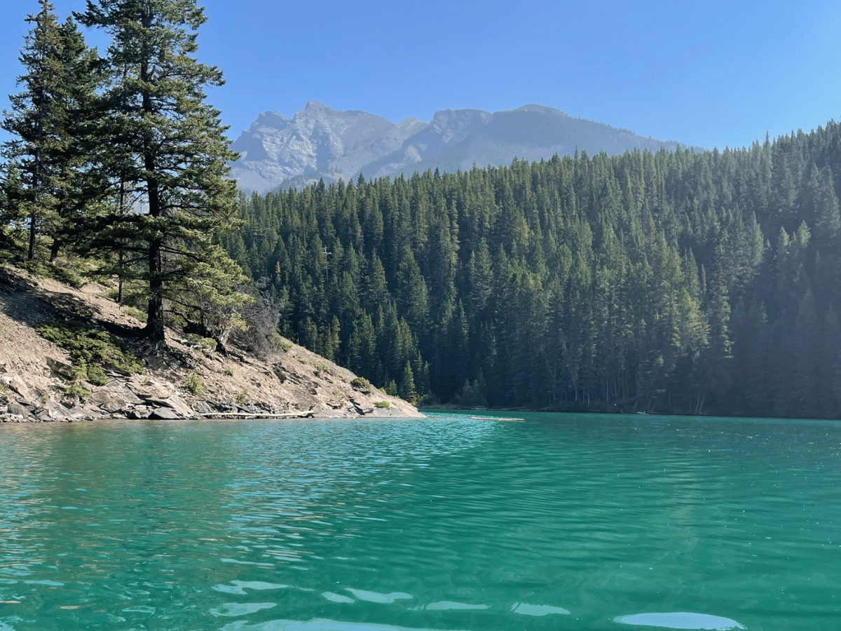 Tourqiuse water with mountains and forest - two jack lake
