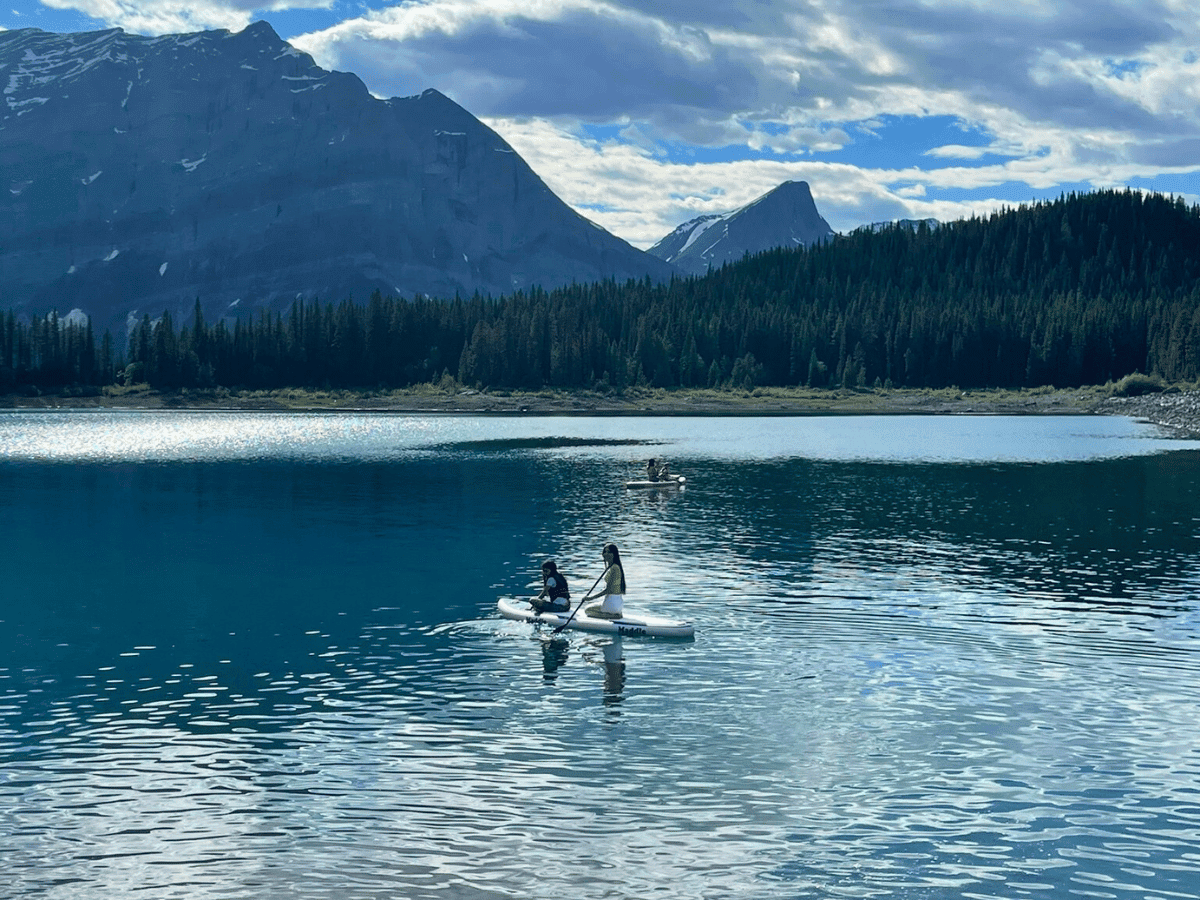 Paddle boarding on a lake with mountain background - Upper Kananaskis Lake