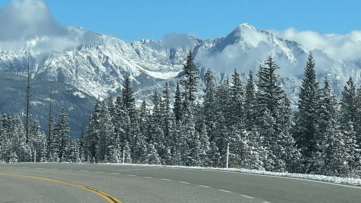 Hwy 93 during winter with snow capped mountains and forested trees