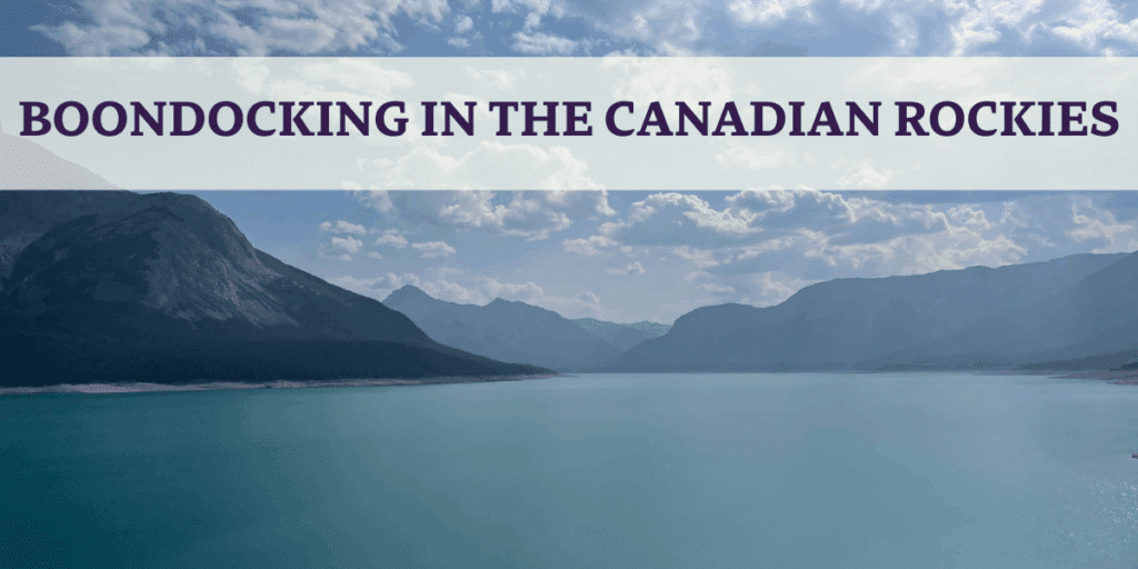 blue lake with cloulds and mountains in the canadian rockies