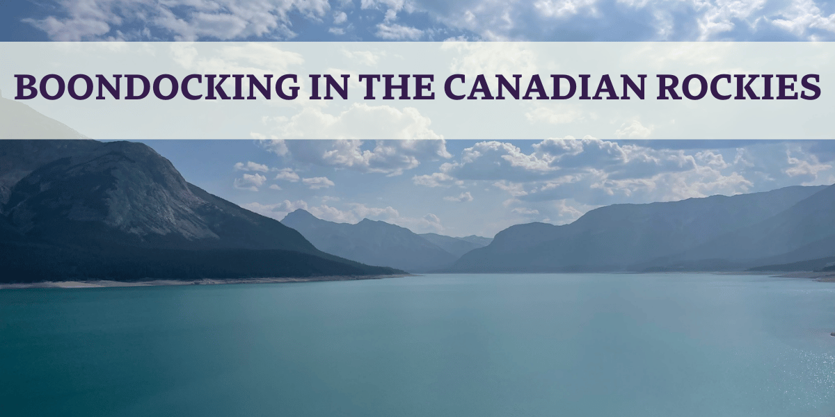 blue lake with cloulds and mountains in the canadian rockies