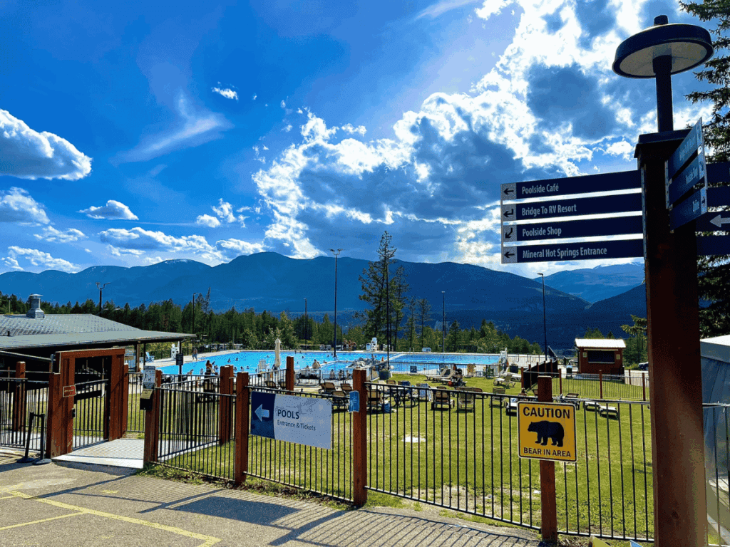 Hot Springs Pool with blue skies and mountain backdrop at Fairmont Hot Springs BC