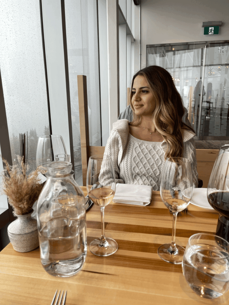 Woman at restaurant looking out the window - Sky Bistro Banff