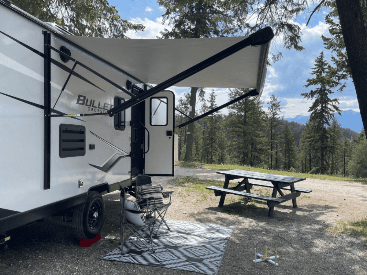 Travel Trailer Set Up at a campground overlooking the forest and mountains