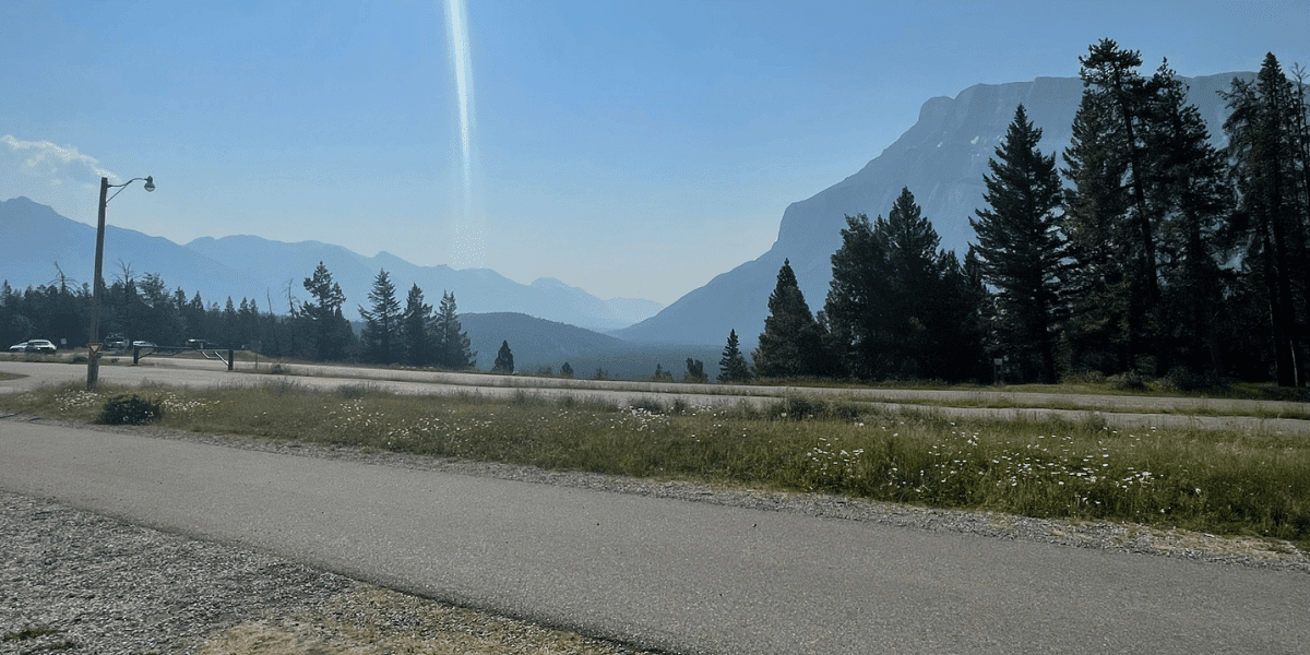 Hazy mountains with trees and blue sky - Tunnel Mountain Banff