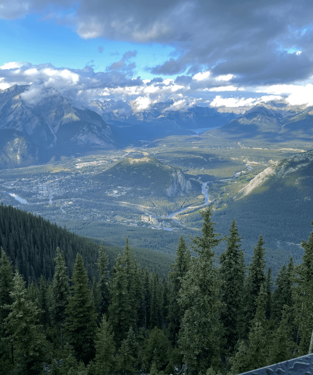 Panoramic view from the Banff Gondola featuring the Bow Valley, Banff townsite, and Rocky Mountain scenery.