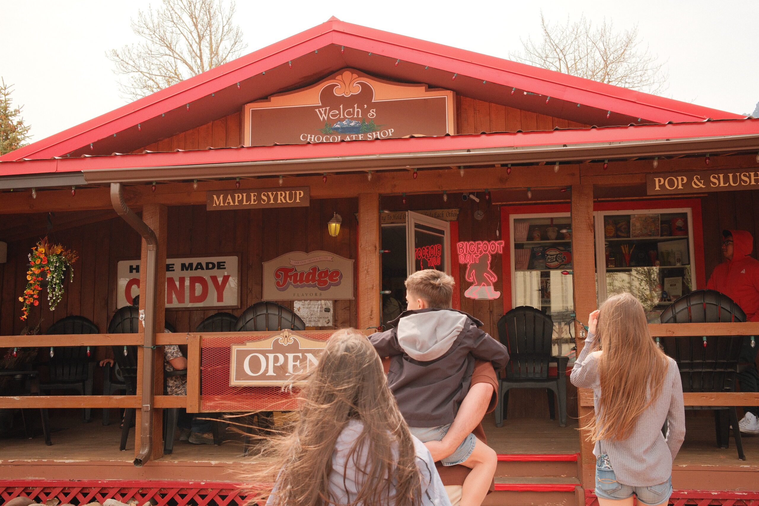 Family visiting Welch’s Chocolate Shop in Waterton townsite, a beloved local candy store near Waterton Lakes National Park known for homemade fudge and sweets.