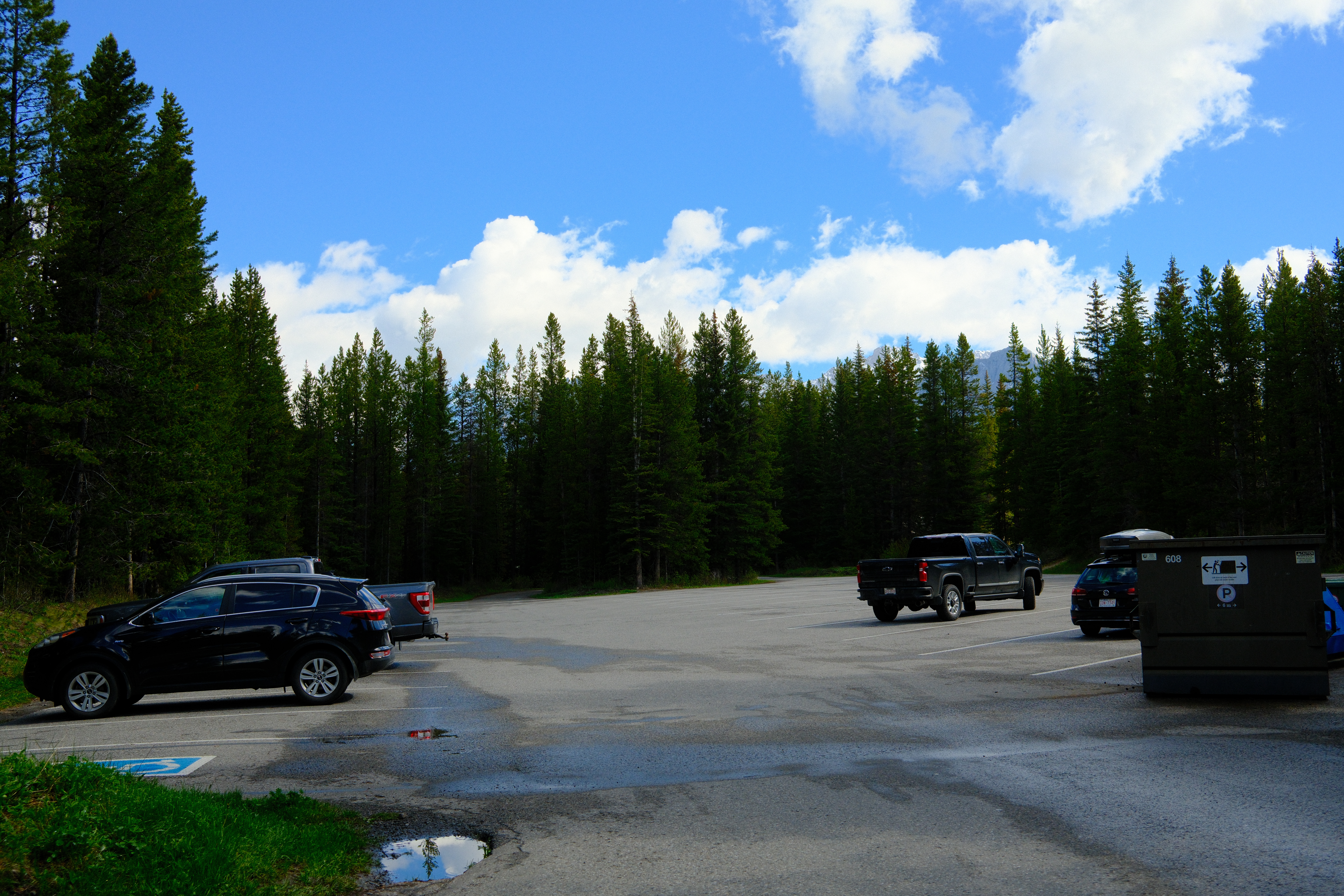 Parking lot in Boulton Creek Campground surrounded by forest with blue skies